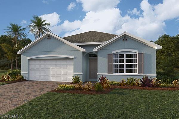 Ranch-style house featuring a garage and a front lawn