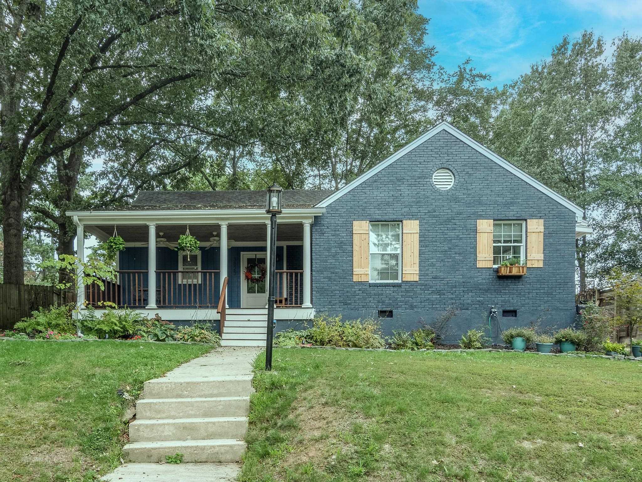 View of front of property with a front lawn and a porch