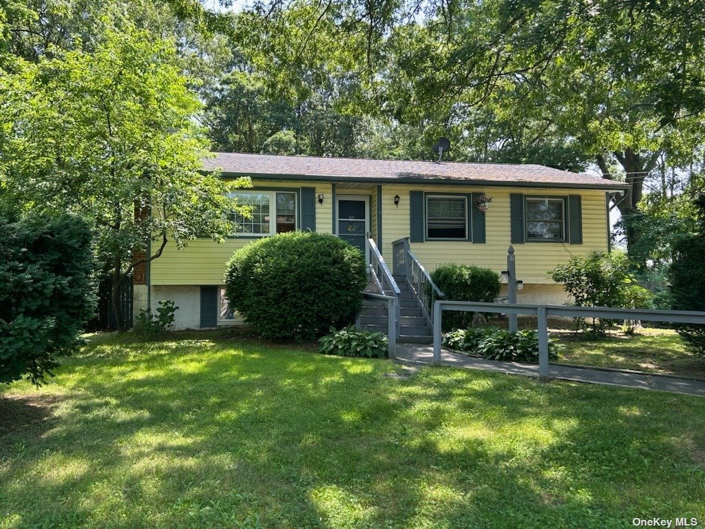 a view of a house with a yard porch and sitting area