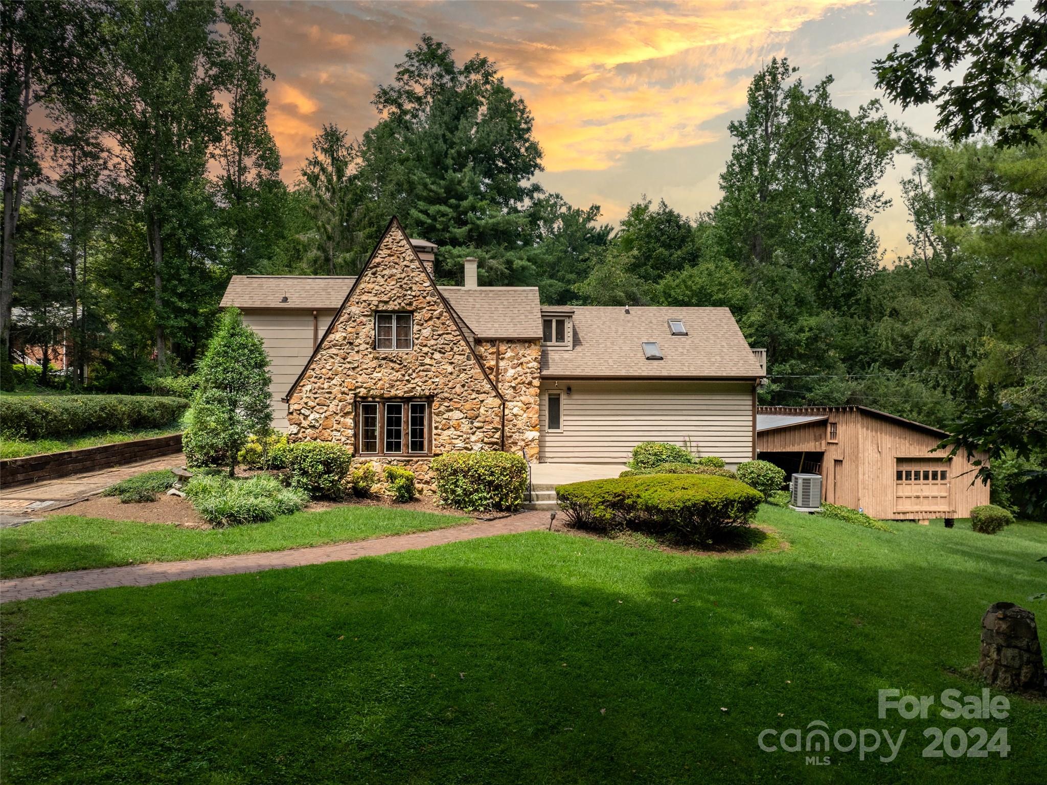 a aerial view of a house with a big yard plants and large trees