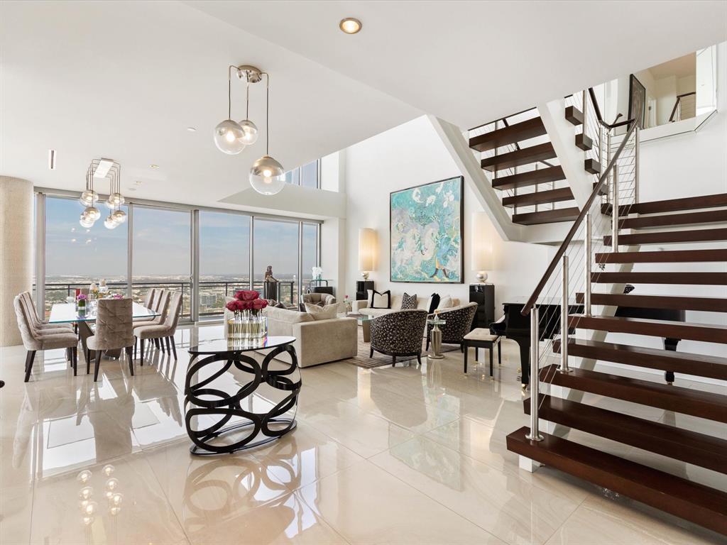 an outdoor space with lots of white furniture and windows