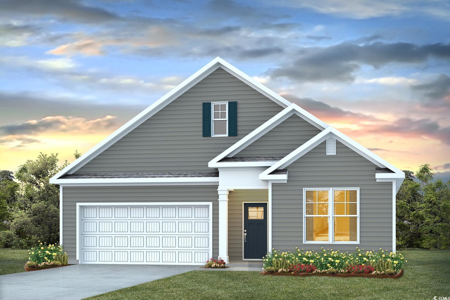 View of front of house with a lawn and a garage