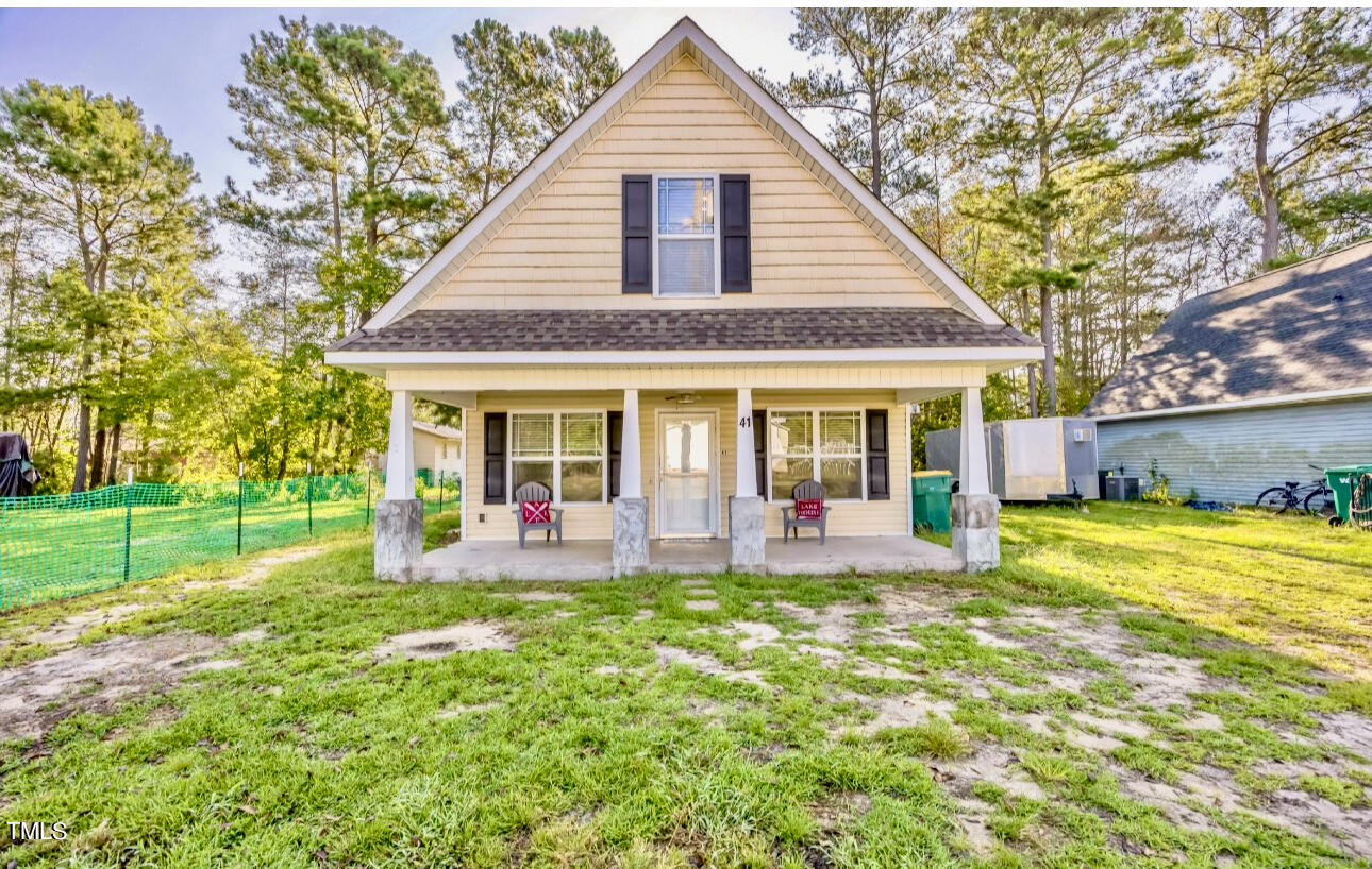 a front view of house with outdoor seating and yard