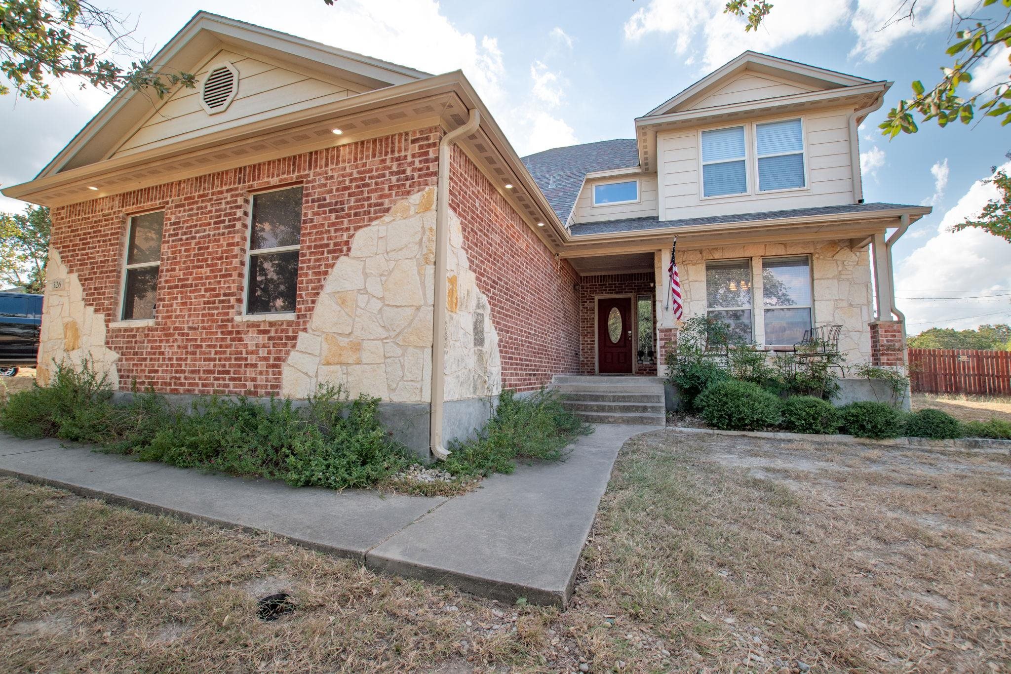 a front view of a house with garden