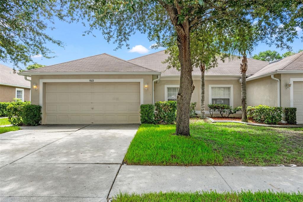 a front view of a house with a yard and garage