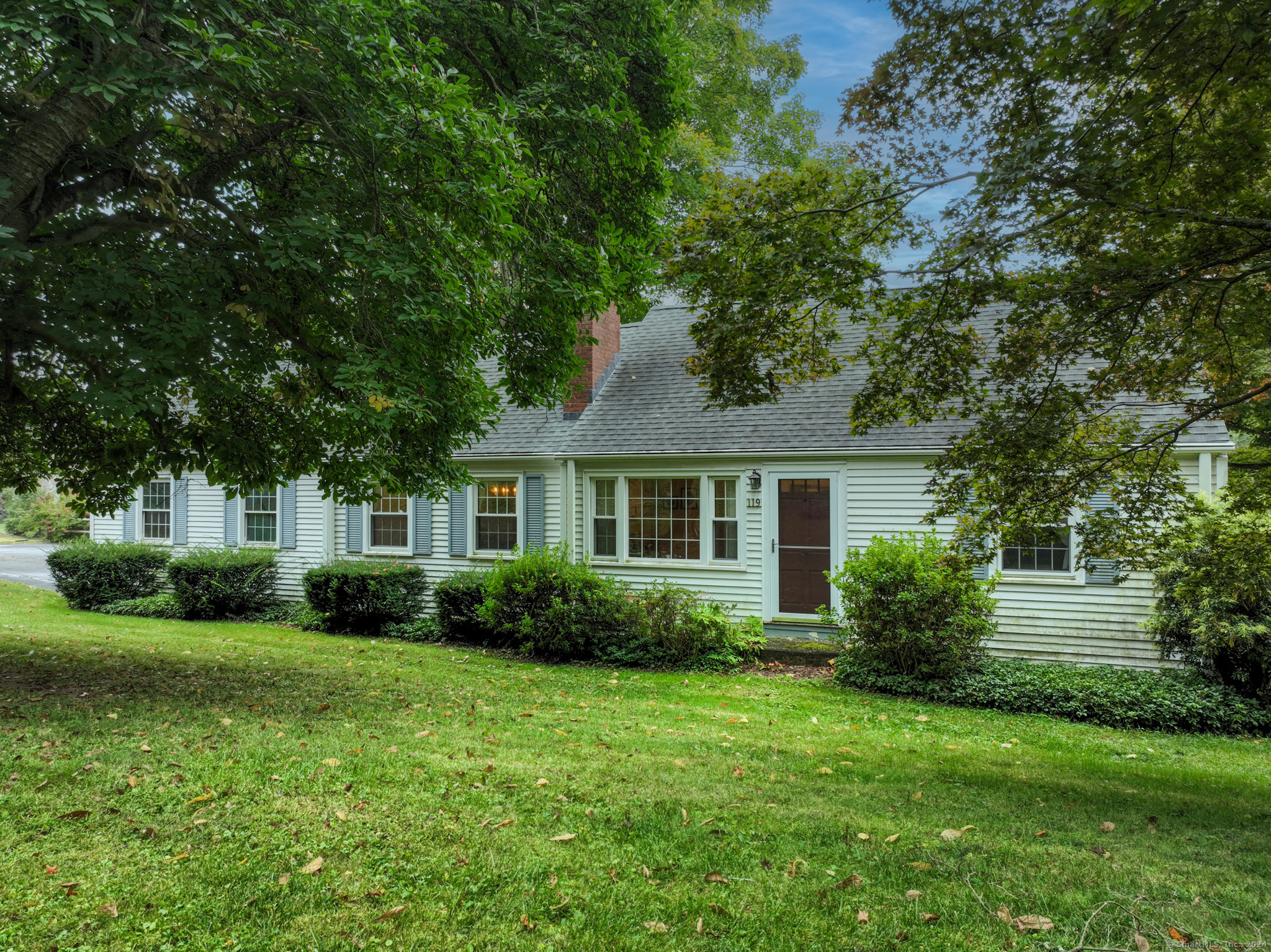 a front view of house with yard and green space