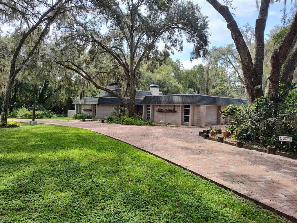 a view of a house with a yard and tree s