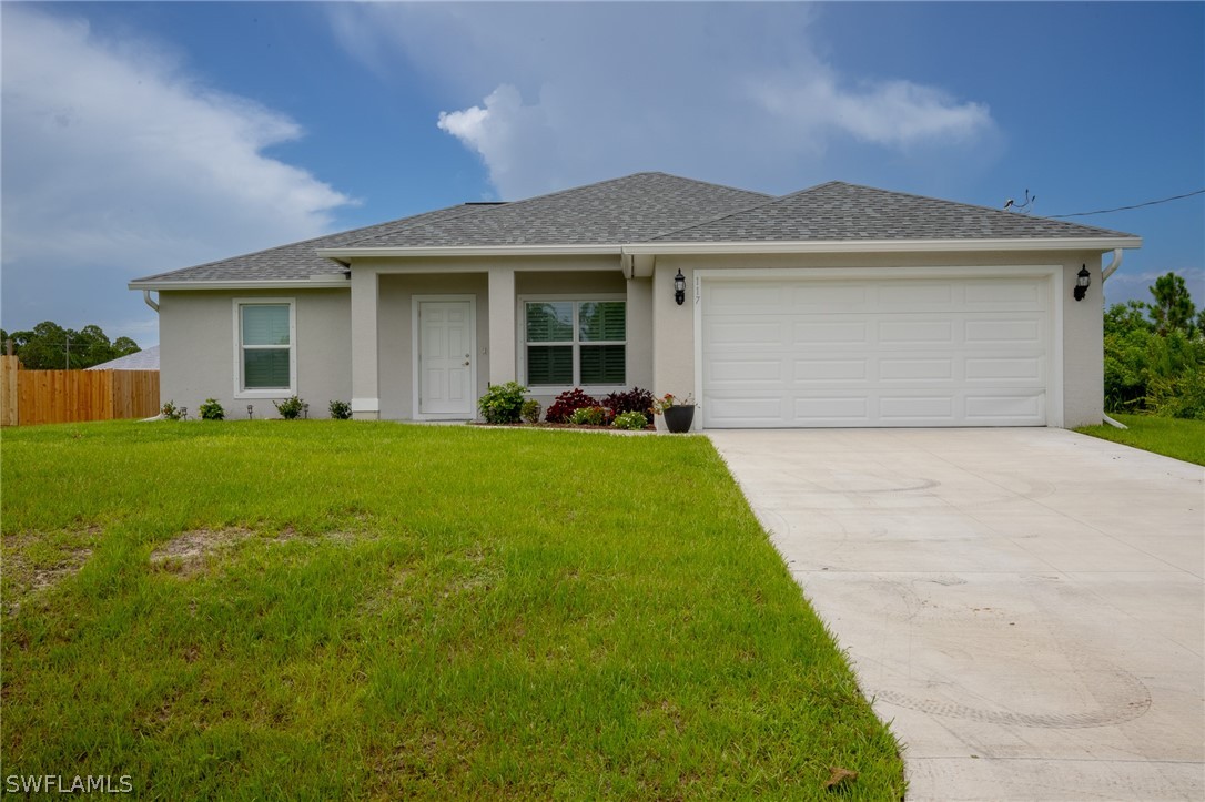 a front view of a house with a yard and garage