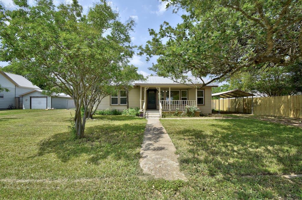 a front view of a house with a yard