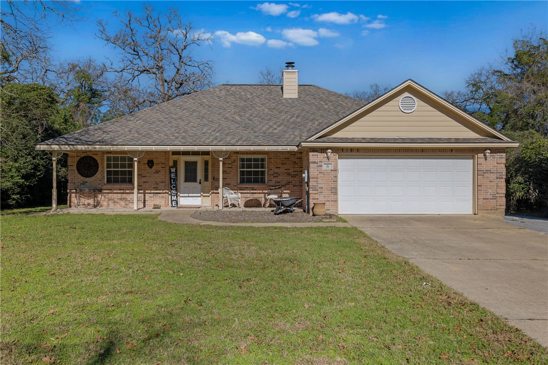 Ranch-style home with a garage, covered porch, and