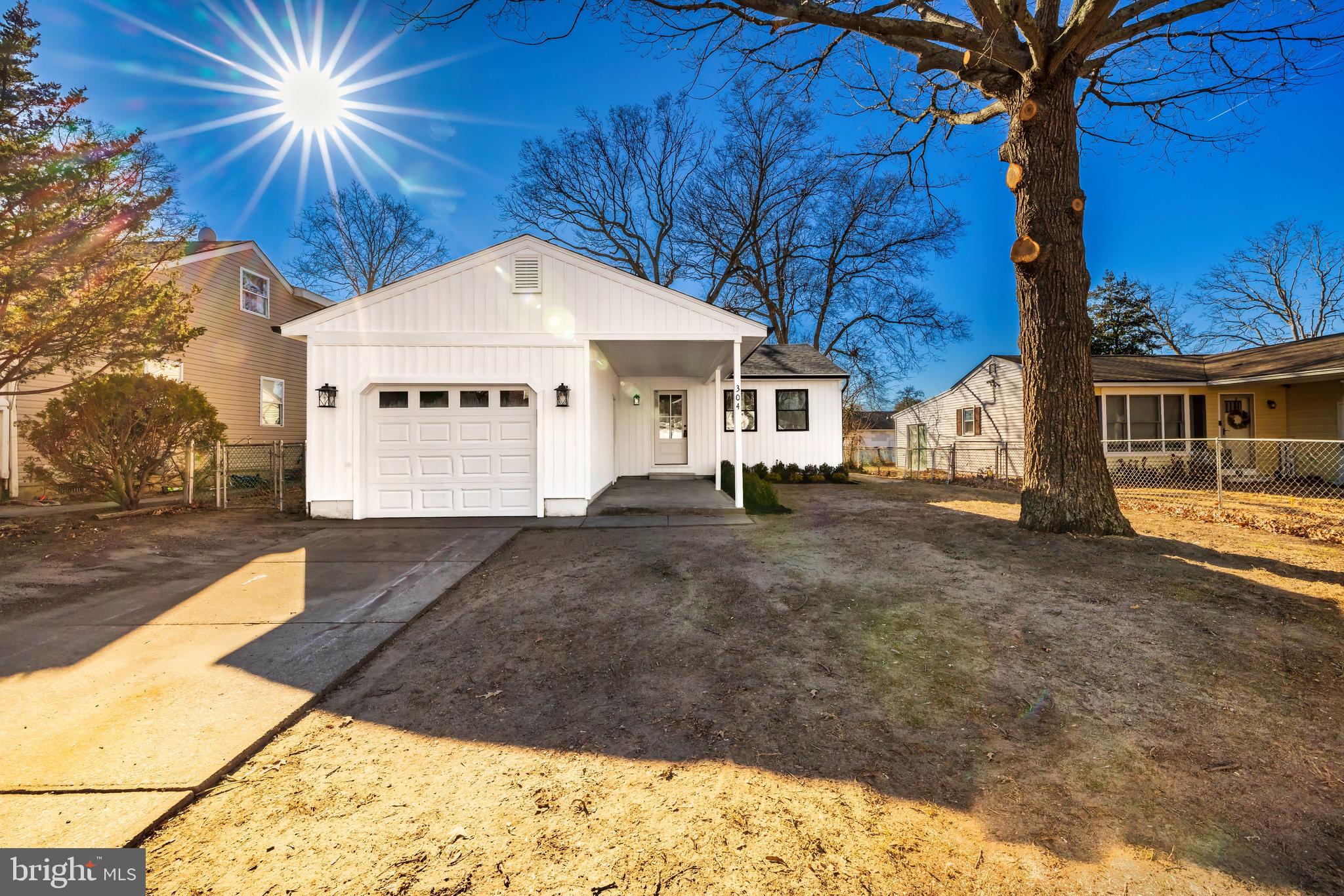 a view of a white house with a yard