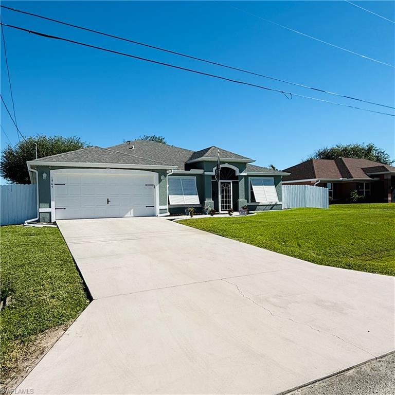 Single story home featuring a front yard and a garage