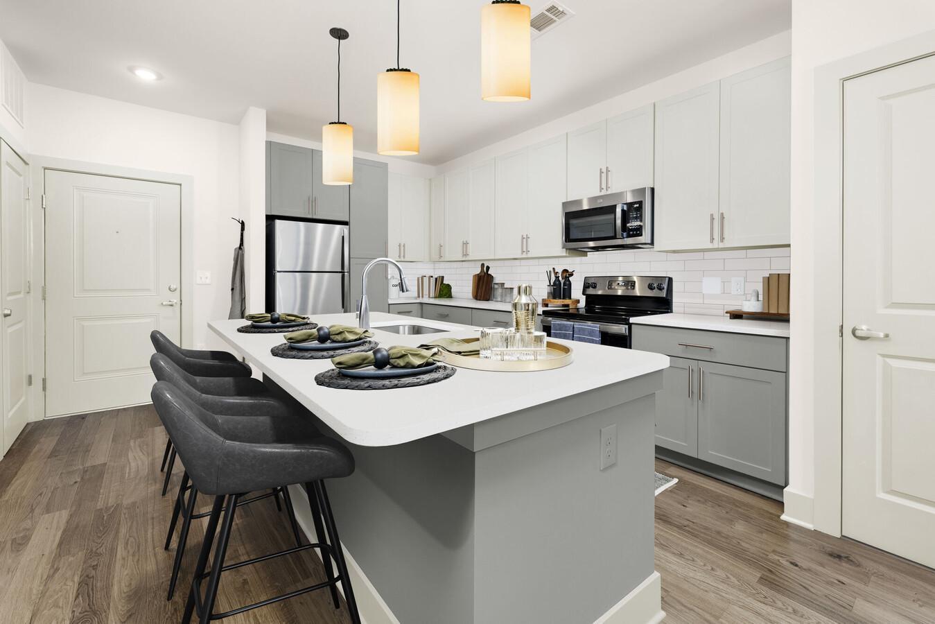 a kitchen with kitchen island a sink table and chairs