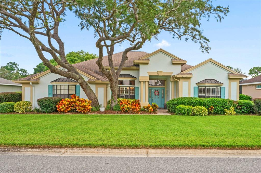 a front view of a house with a garden