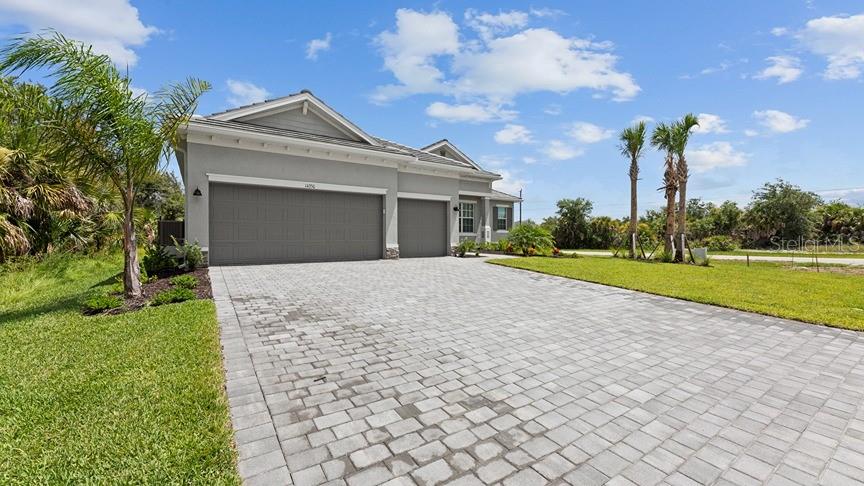 a front view of a house with a yard and garage