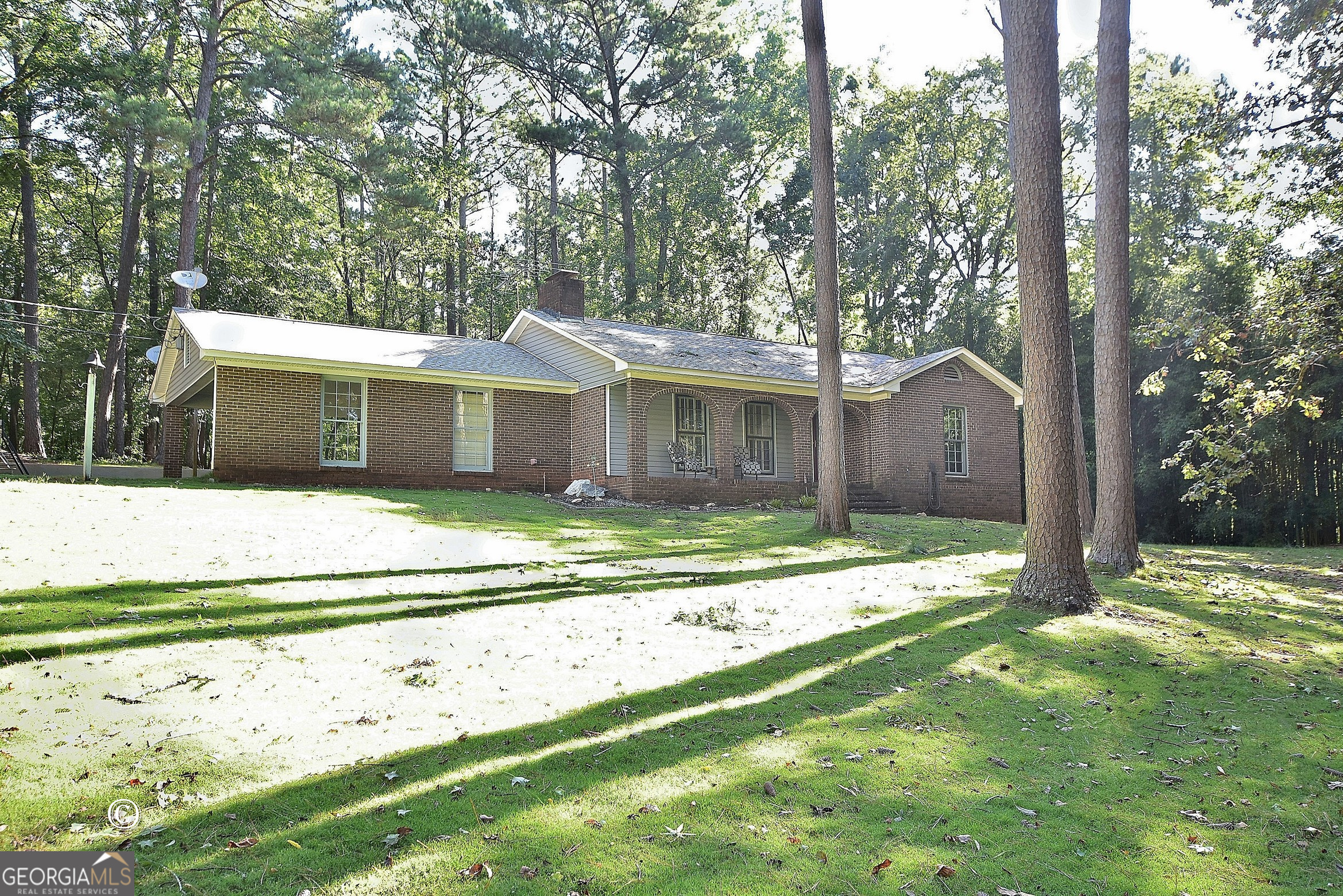 a view of a house with a backyard and a tree