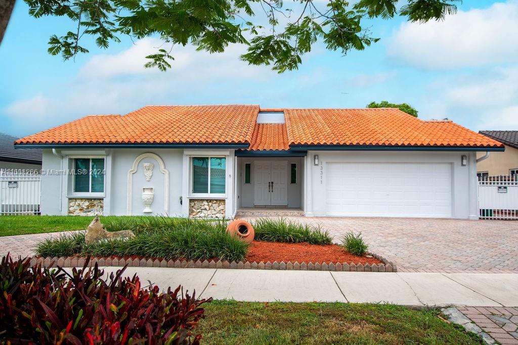 a front view of a house with a garden