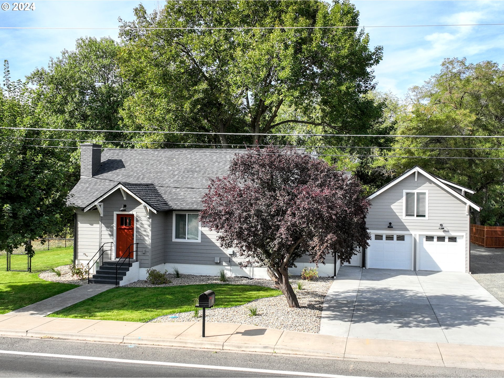 a view of house with a yard and street view