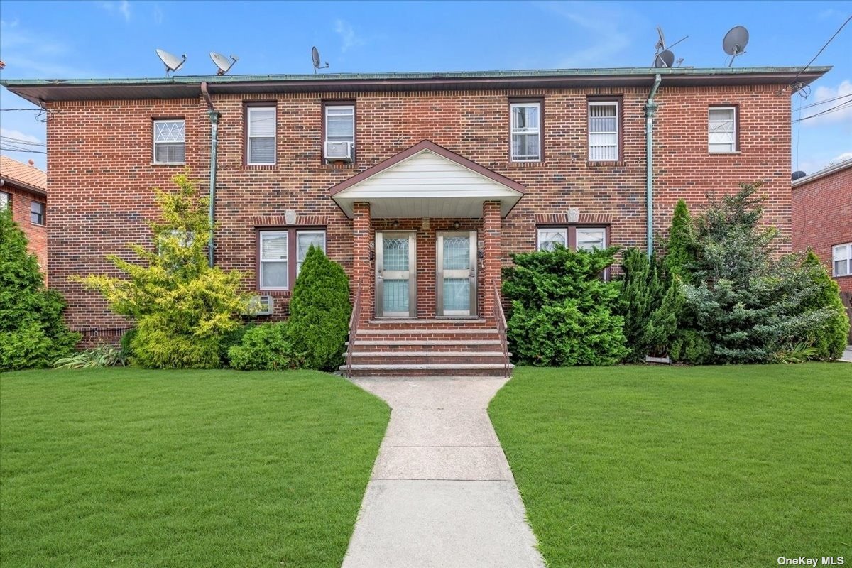 a front view of a house with garden