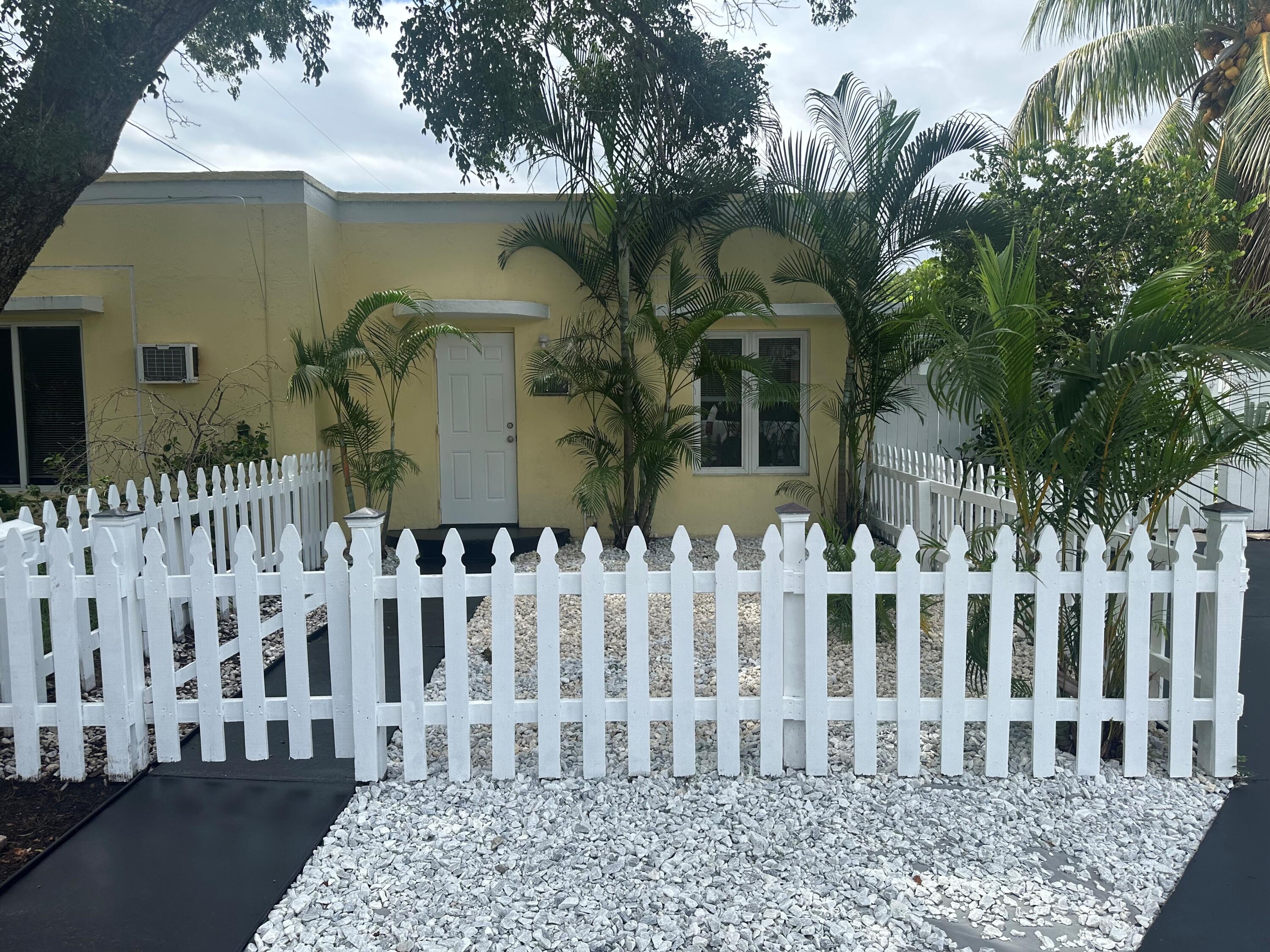 a view of a house with wooden fence