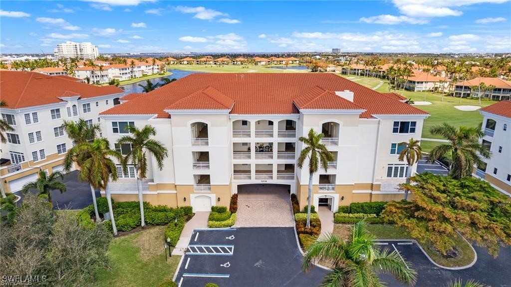 an aerial view of residential houses with outdoor space and ocean view