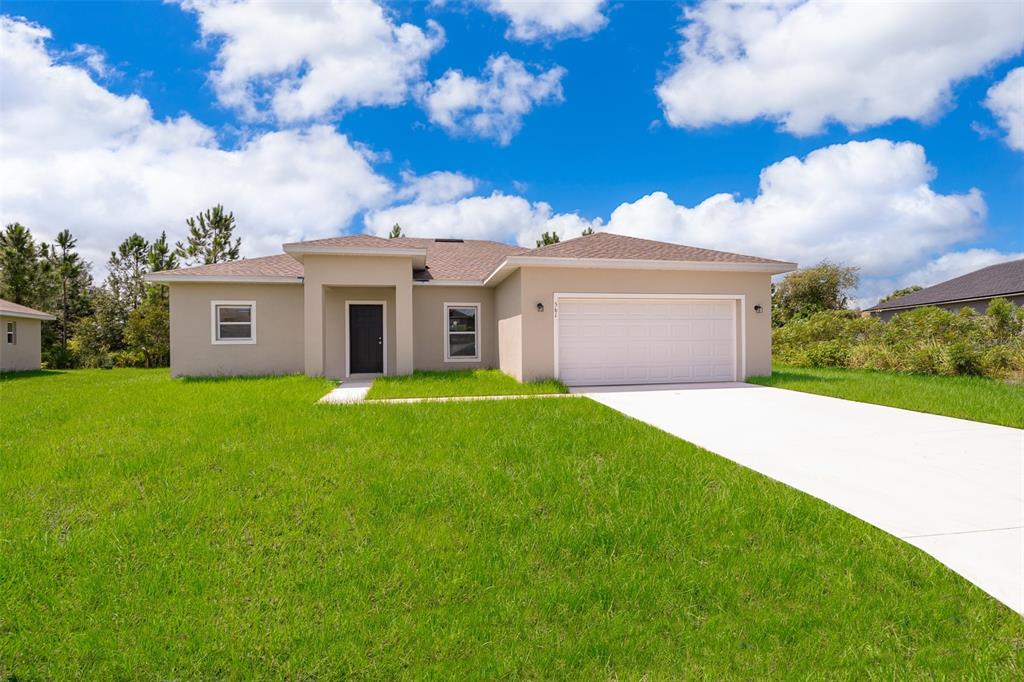 a view of a house with a backyard