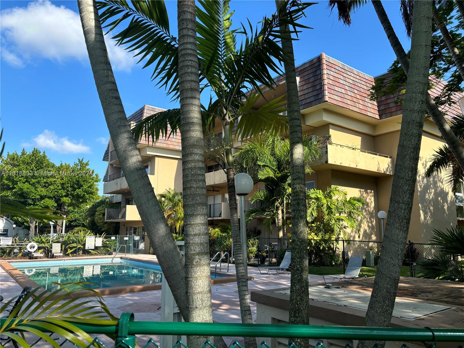 a front view of multi story residential apartment building with yard