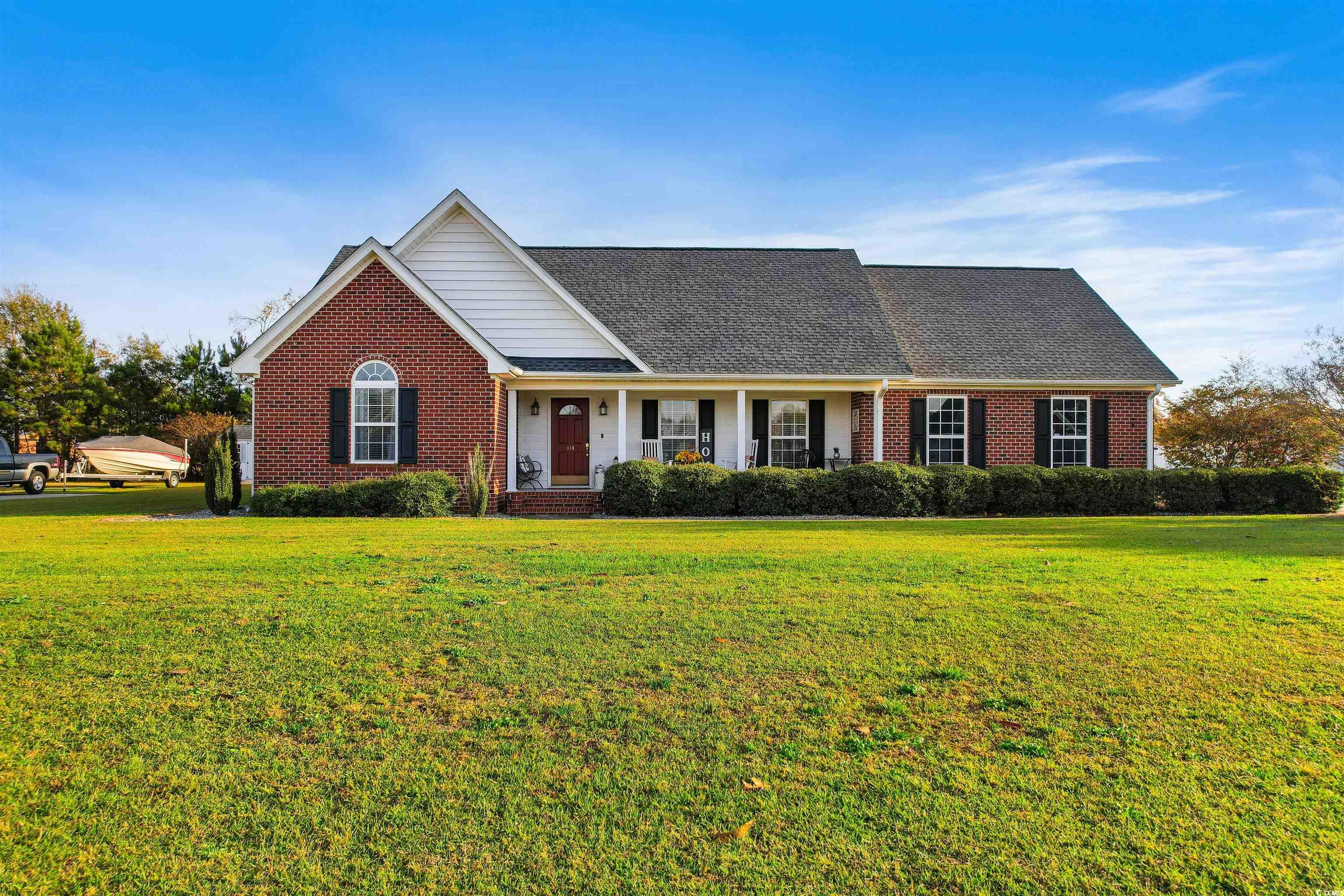 View of front of home featuring a front yard and c