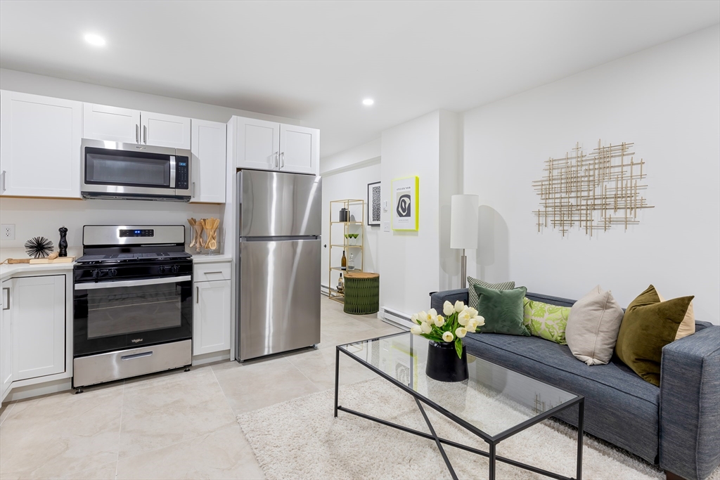 a kitchen with stainless steel appliances a refrigerator and a stove top oven