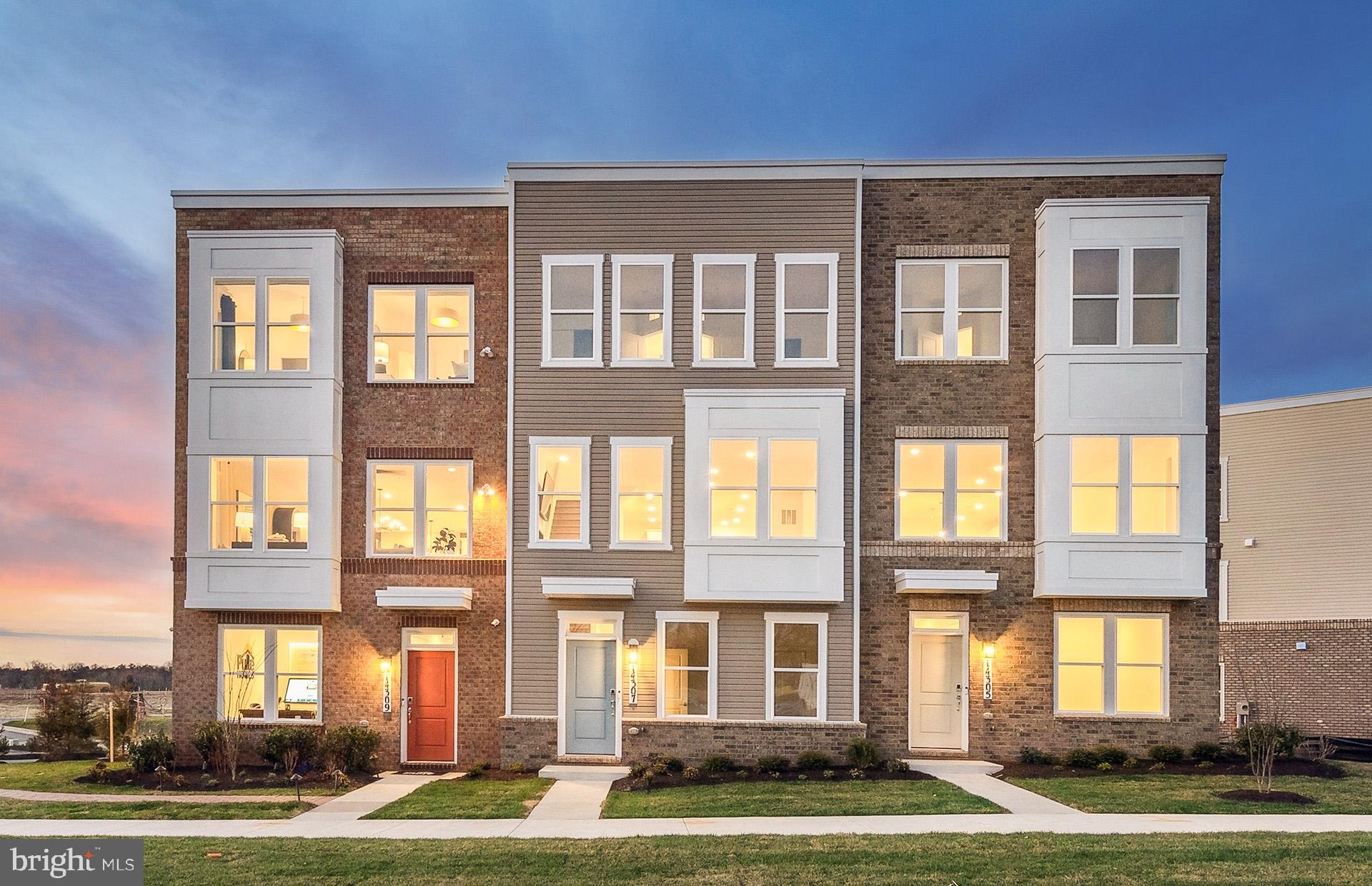 a front view of a residential apartment building with a yard