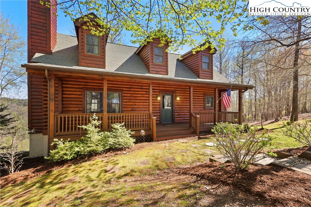 a house that has a tree in front of the house