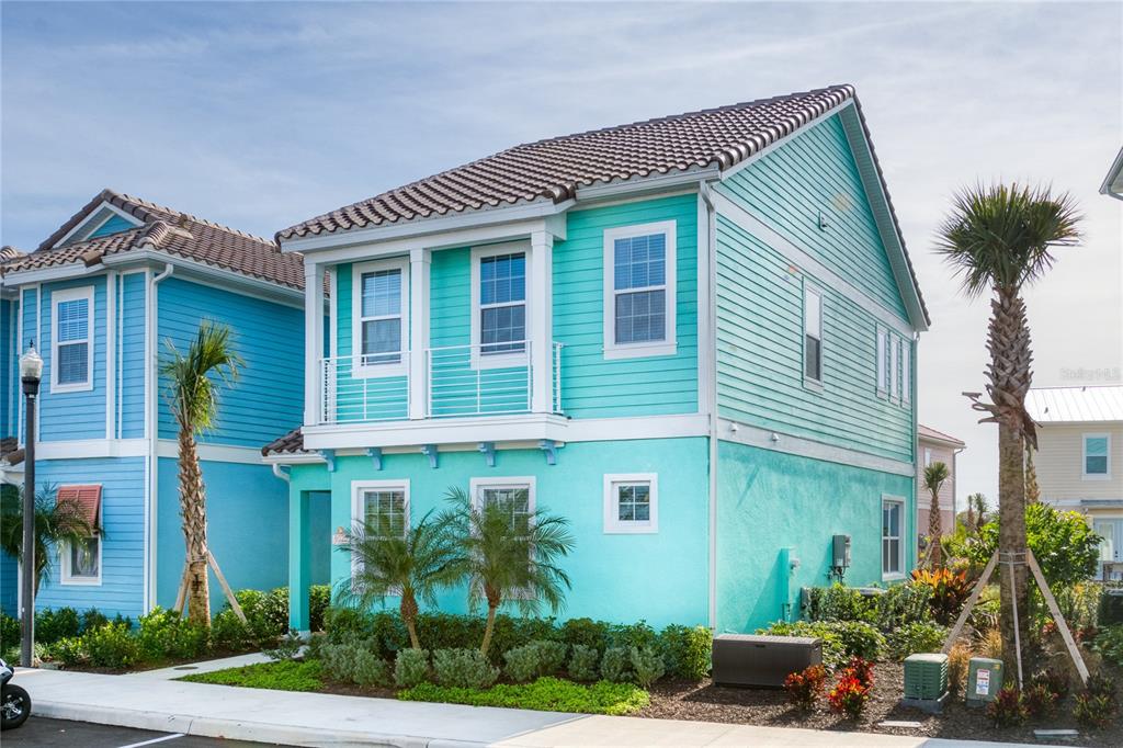 a front view of a house with plants