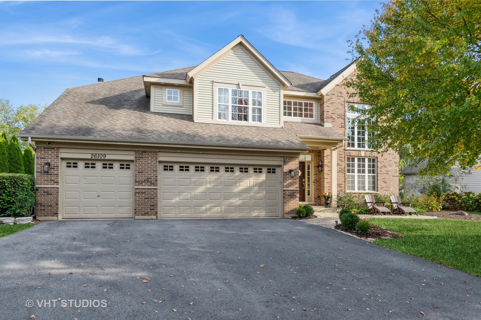 a front view of a house with a yard and garage