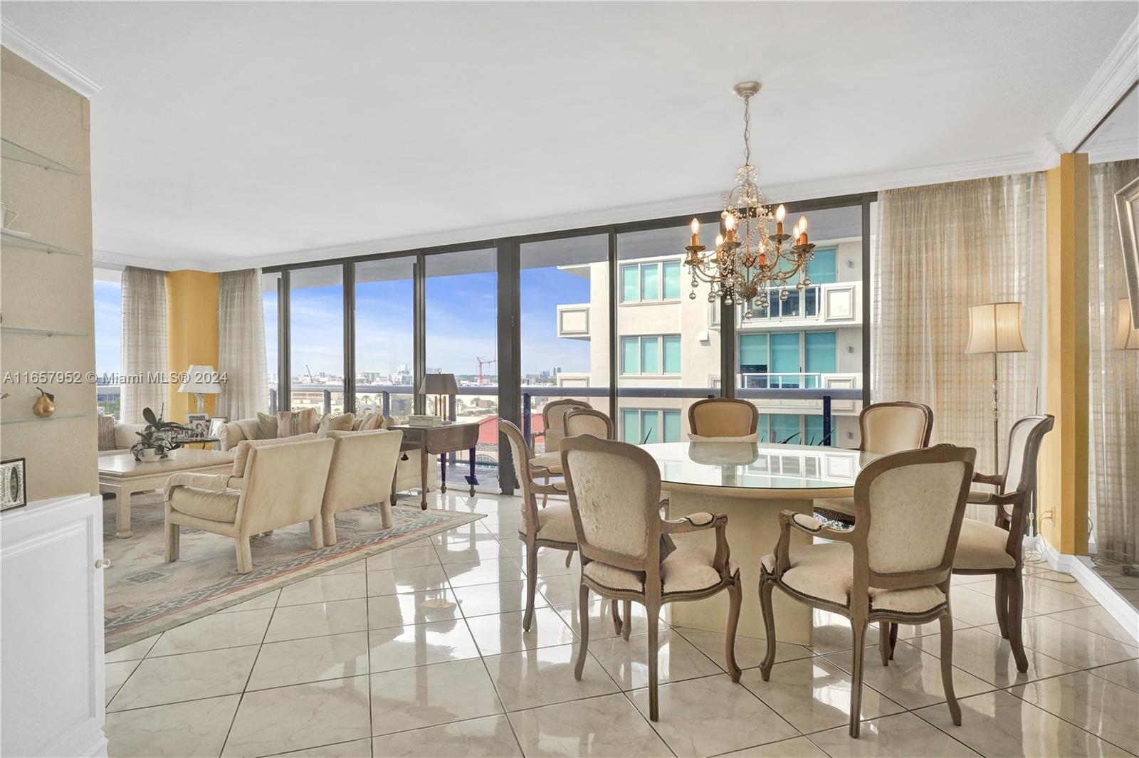 a dining room with furniture a chandelier and wooden floor