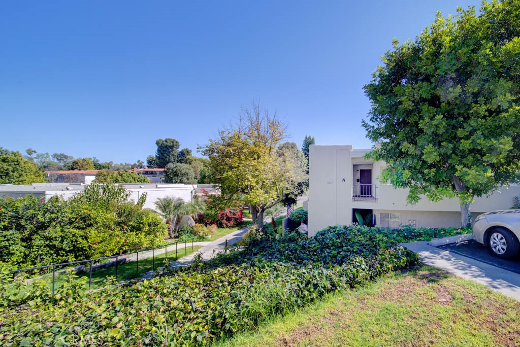 an aerial view of a house with a yard and lake view