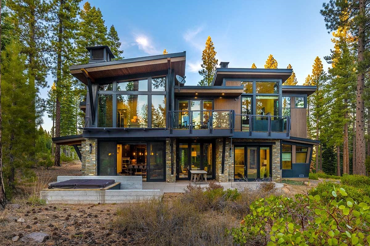 a front view of a house with porch and outdoor seating