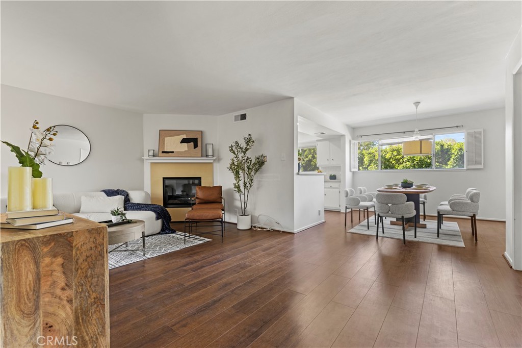 a living room with fireplace furniture and a wooden floor