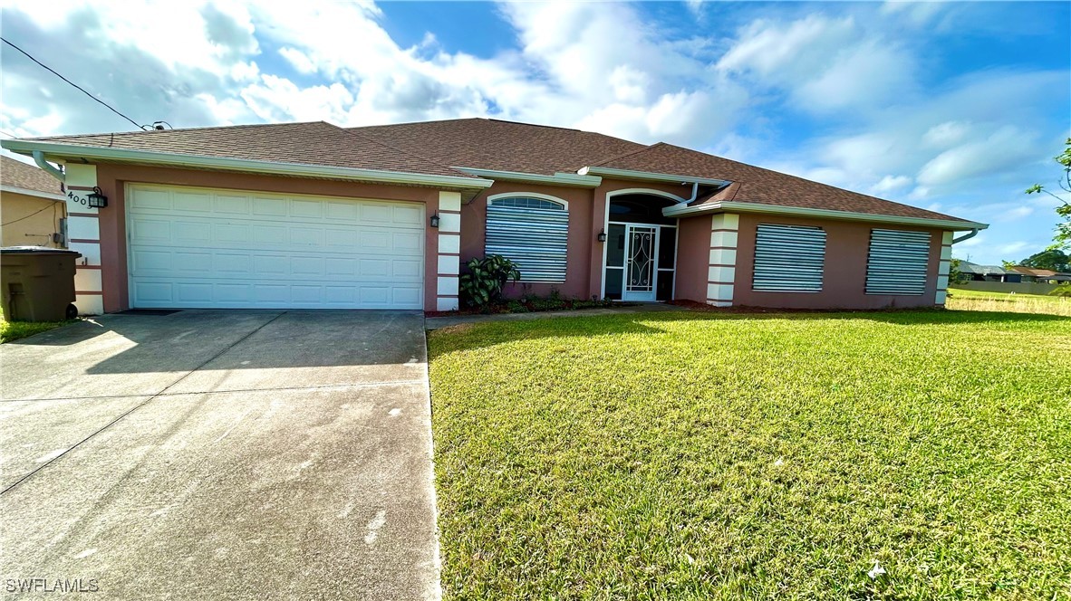 a front view of a house with yard and garage