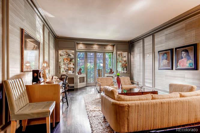 a living room with furniture and large windows