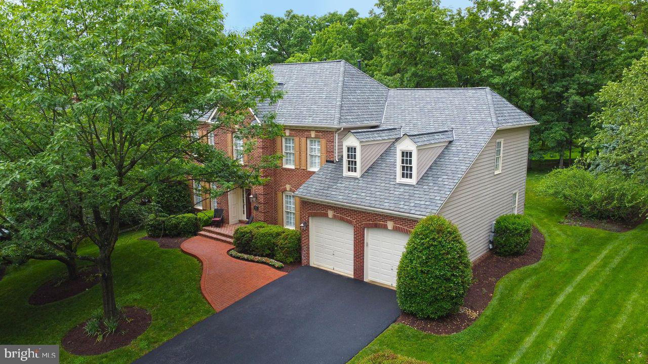 an aerial view of a house with a yard and a garage