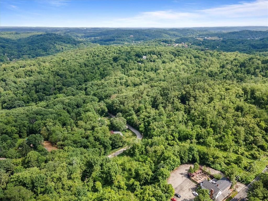 an aerial view of a houses with a yard