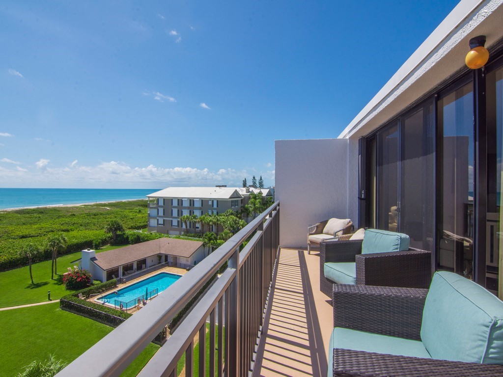 a balcony with table and chairs