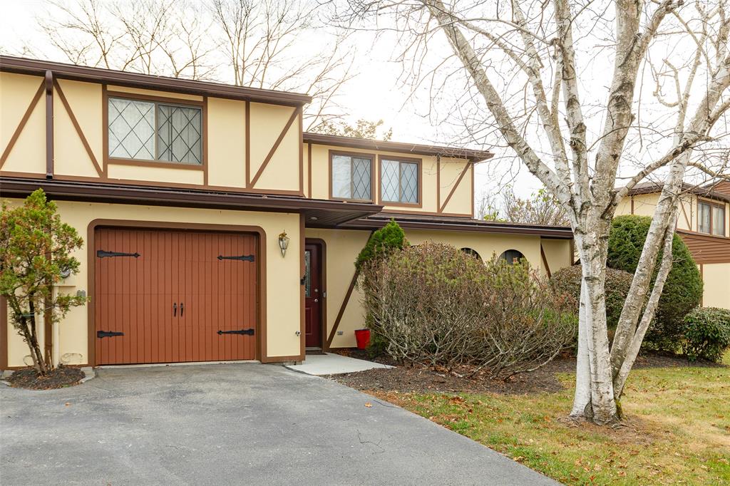 English style home with a garage