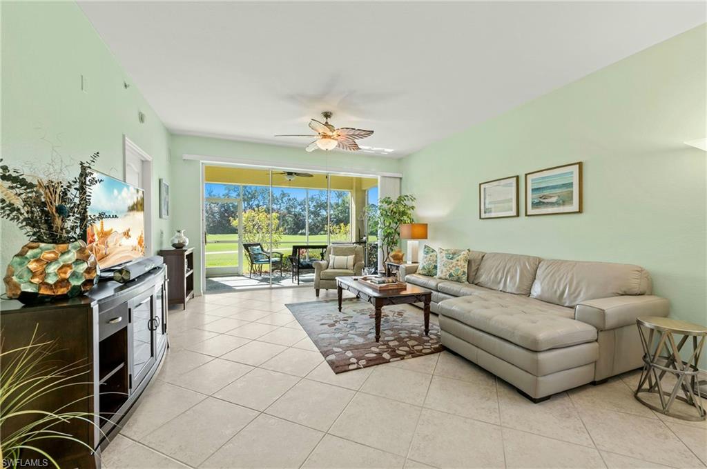 a living room with furniture a fireplace and a large window