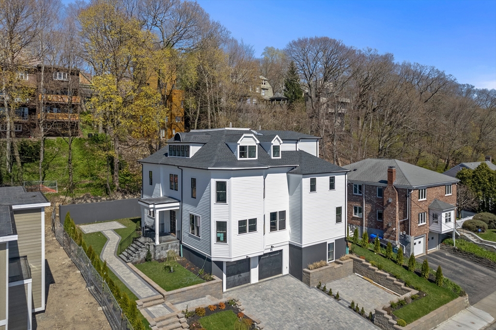 an aerial view of a house with a big yard