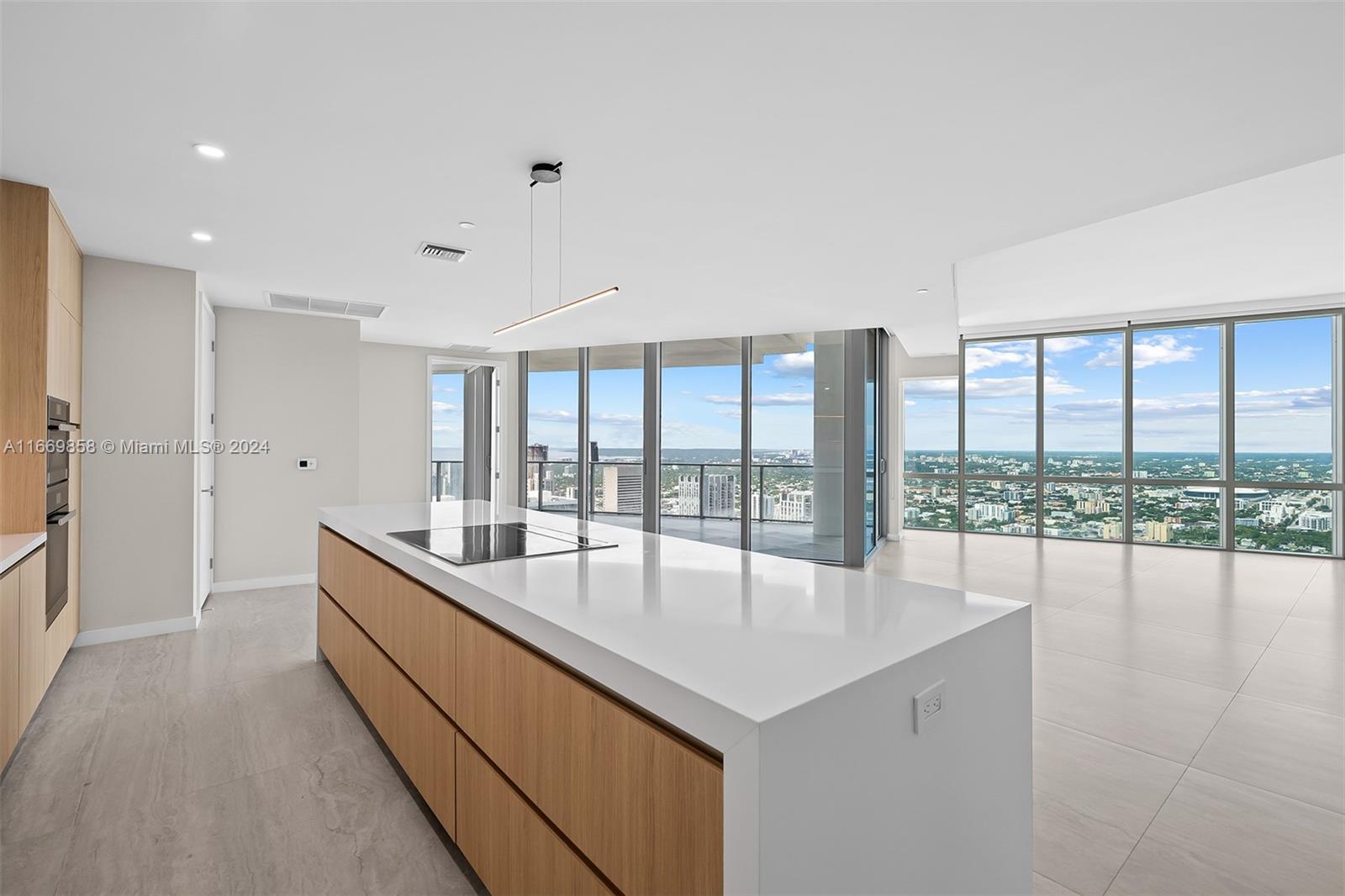 a large white kitchen with a large window