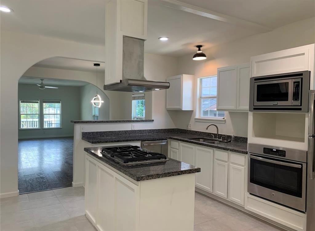 a kitchen with a stove and a microwave