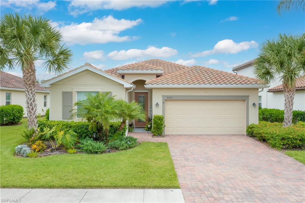 Mediterranean / spanish-style house featuring a garage and a front yard