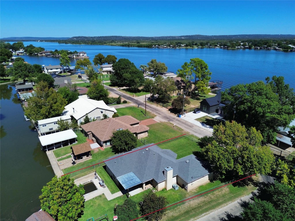 an aerial view of ocean with residential house with outdoor space