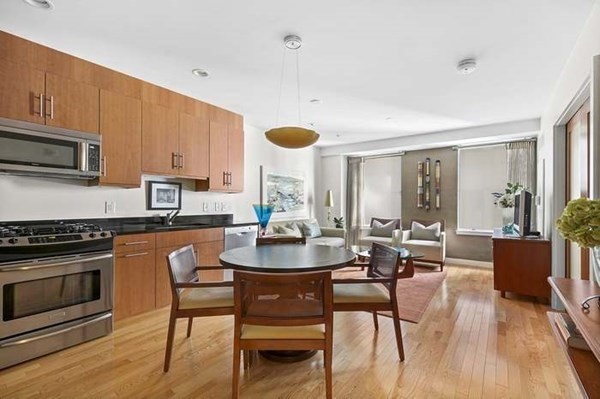 a kitchen with a table chairs stove and microwave